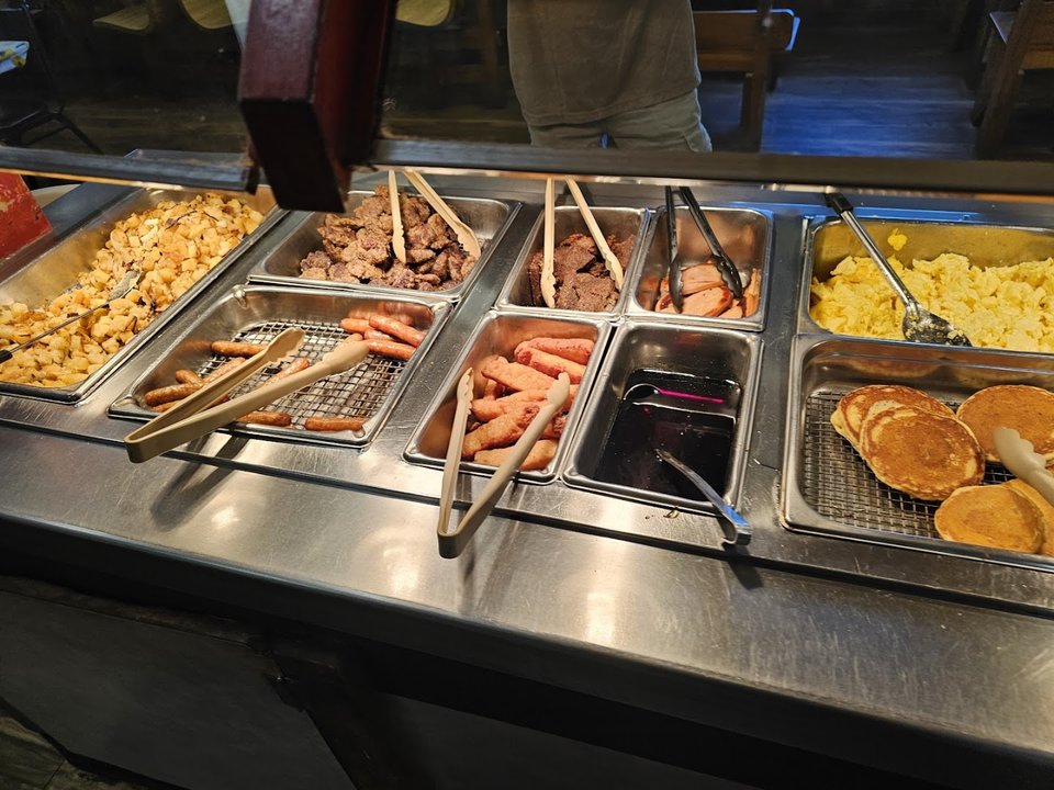 Cafe tables with breakfast plates and coffee.